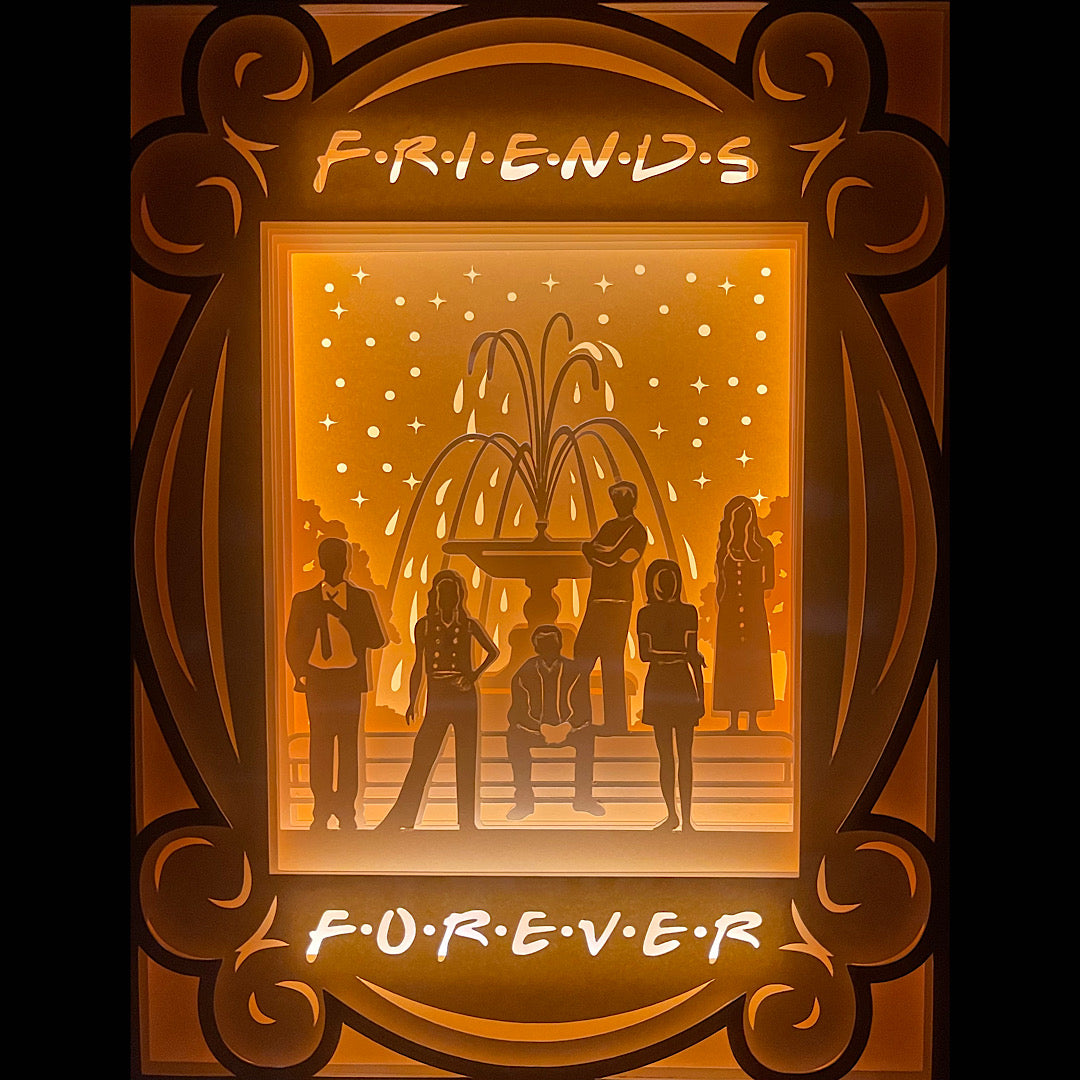 Friends, série Friends, Central Perk, New York, sitcom culte, Rachel Green, Monica Geller, Phoebe Buffay, Joey Tribbiani, Chandler Bing, Ross Geller, canapé orange, fontaine Friends, années 90, générique culte, humour, amitié, série télé culte, Warner Bros, univers comédie, tableau lumineux, lightbox, shadowbox, cadre lumineux, papier découpé, art lumineux, décoration murale, idée cadeau série, déco geek, cadeau fan Friends